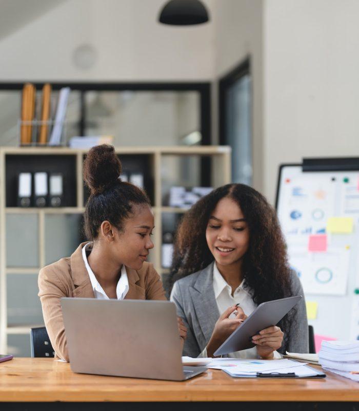 two-young-business-people-working-together-in-office